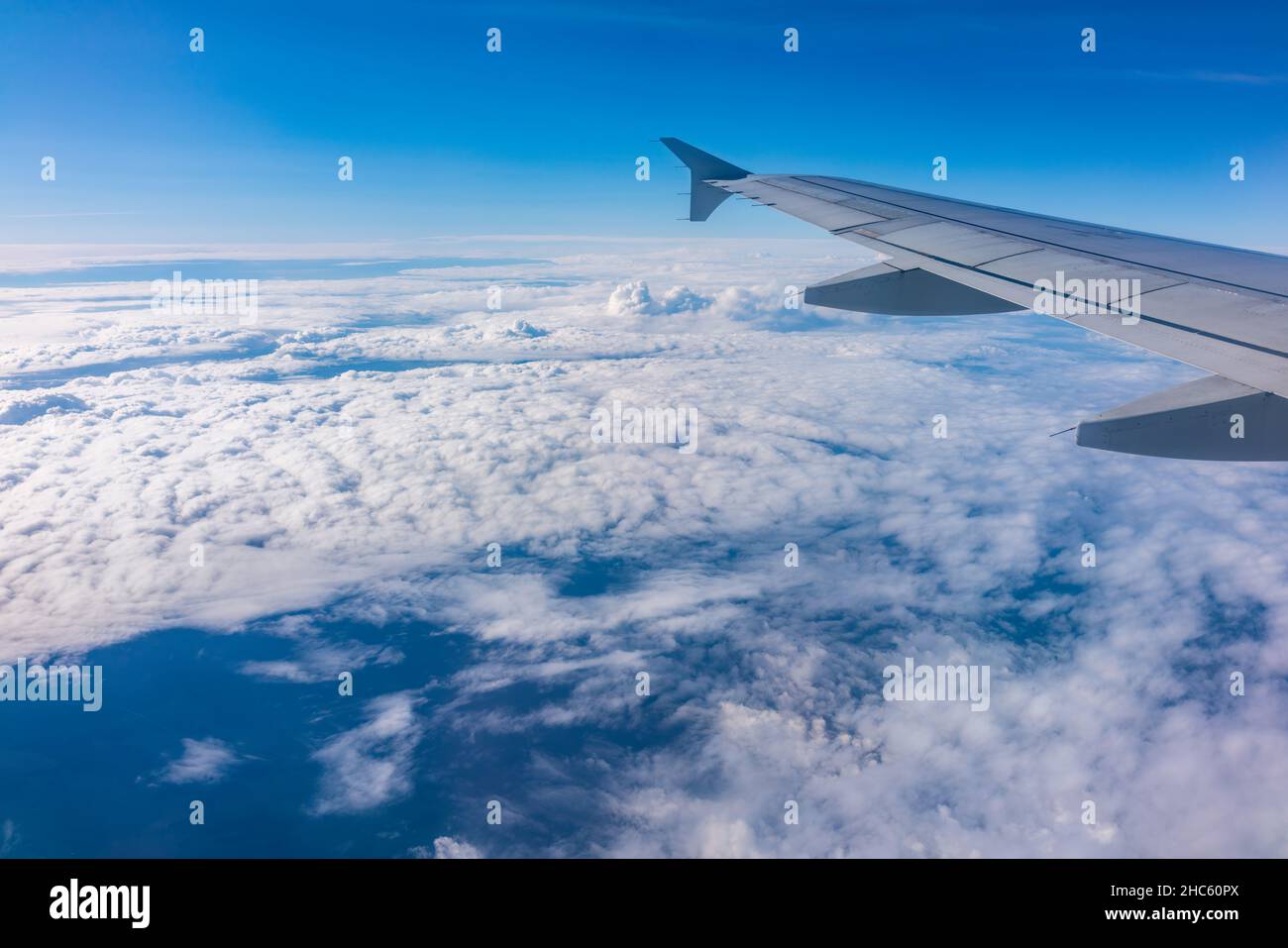 View from the airplane window at a beautiful cloudy sky and the ...