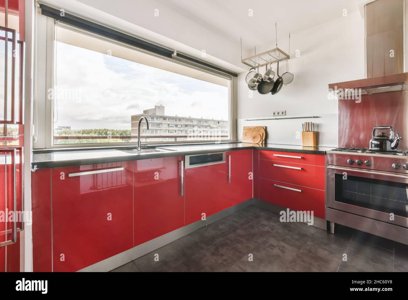 Stylish kitchen design with bright red kitchen set Stock Photo - Alamy