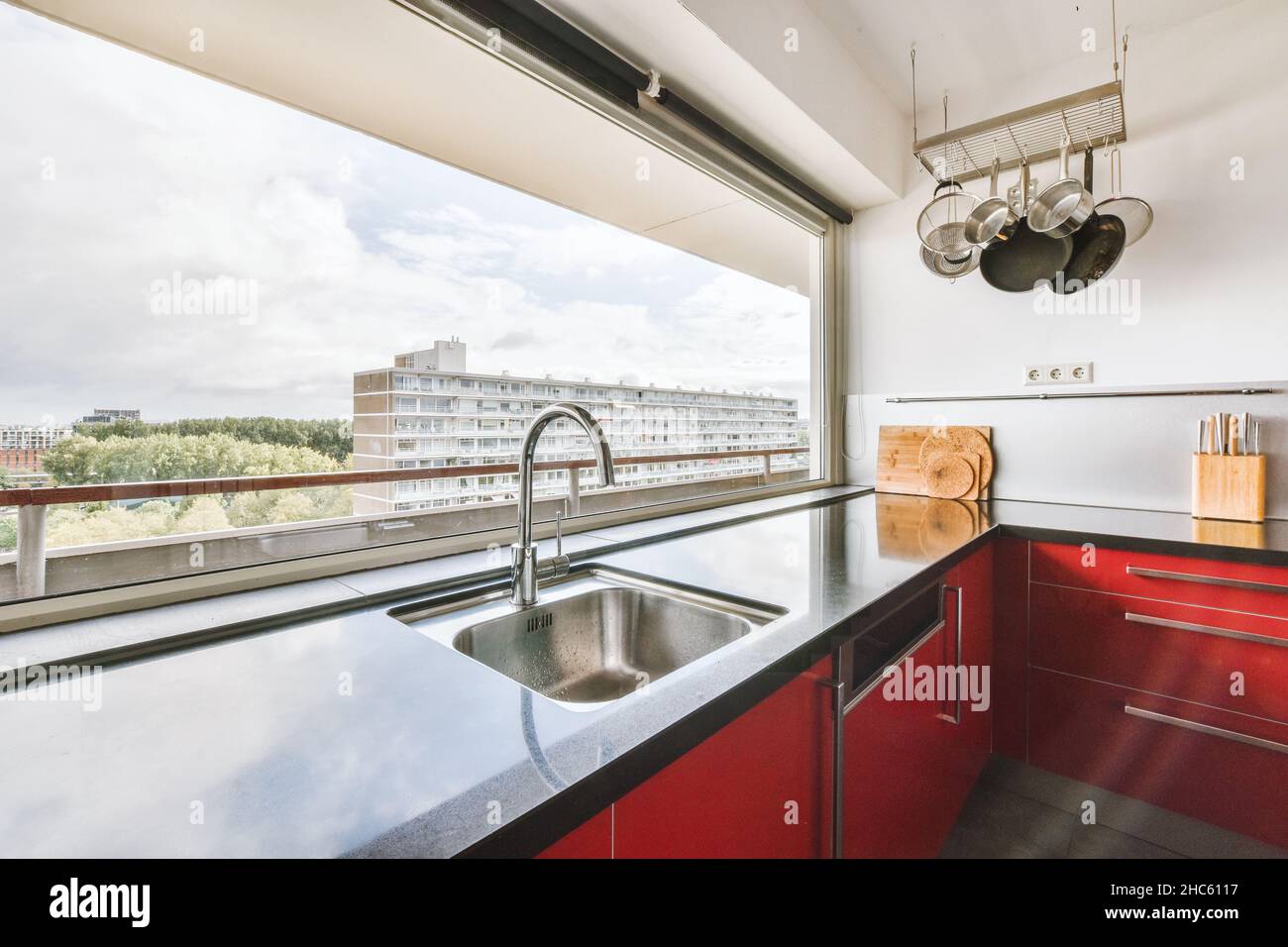 Stylish kitchen design with bright red kitchen set Stock Photo - Alamy
