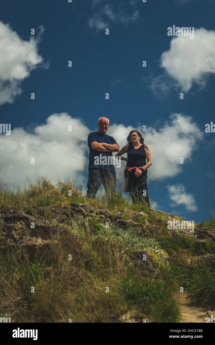Old couple standing on the top of the hill after hiking Stock Photo - Alamy