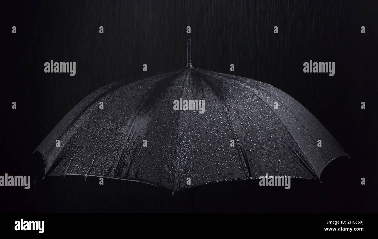 Photo of the black umbrella and rainy drops on black background Stock ...