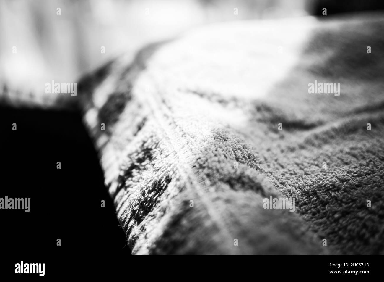 Closeup of sunrays on a cloth material in greyscale Stock Photo