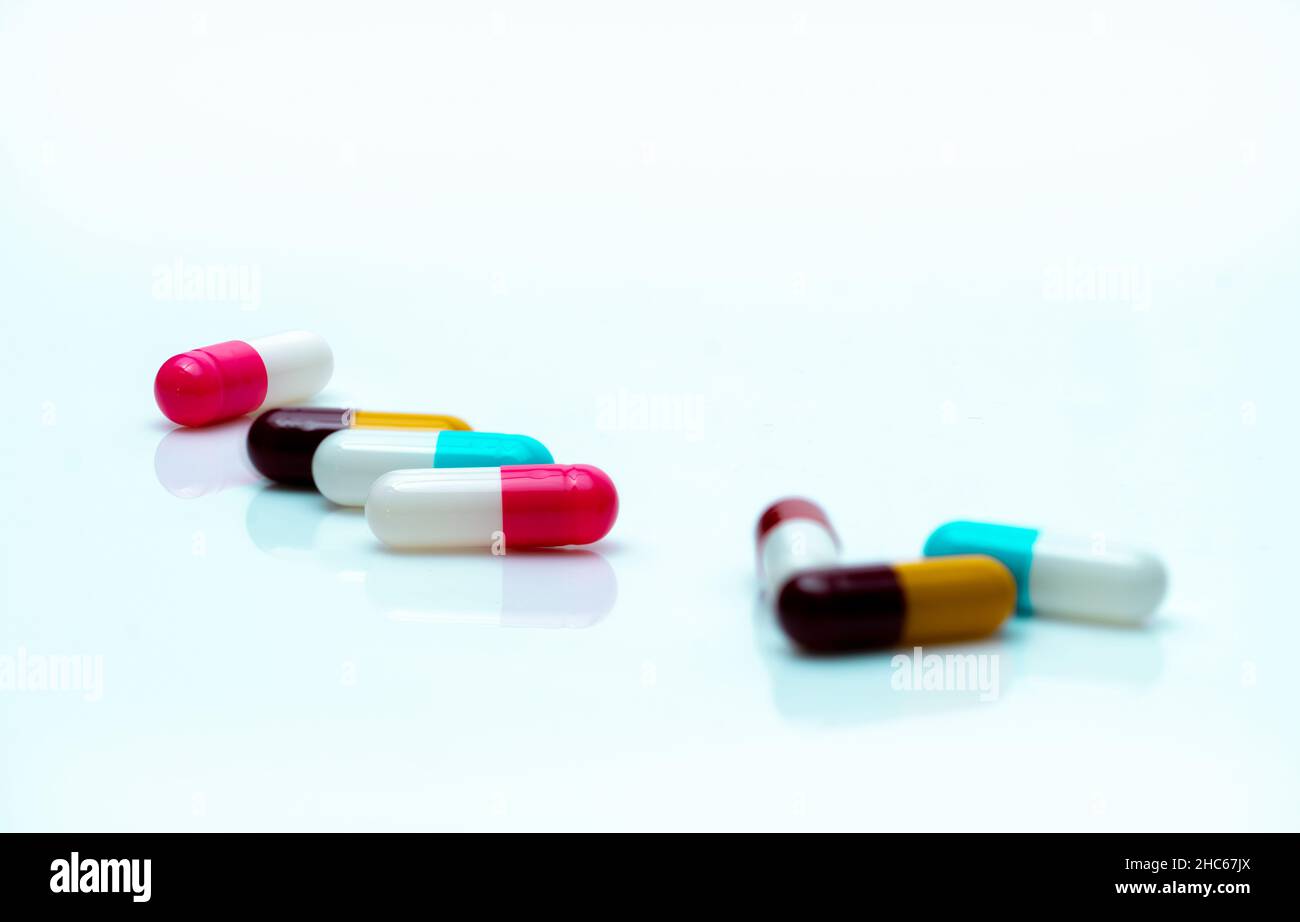 Antibiotic capsule pills on white background. Prescription drugs. Colorful capsule pills