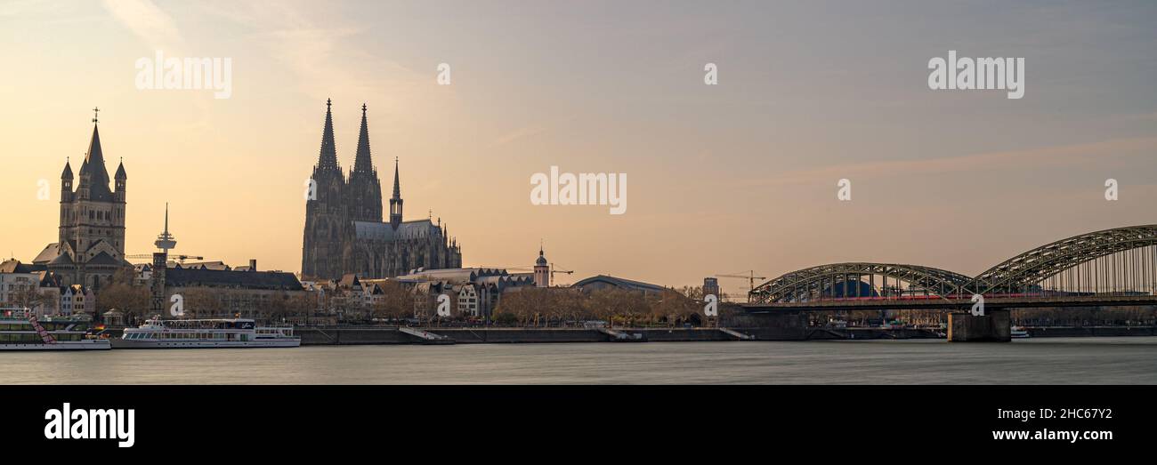 A panoramic shot of the modern buildings in Koln by the sea under a sky with sunset,  Cologne, Germany Stock Photo