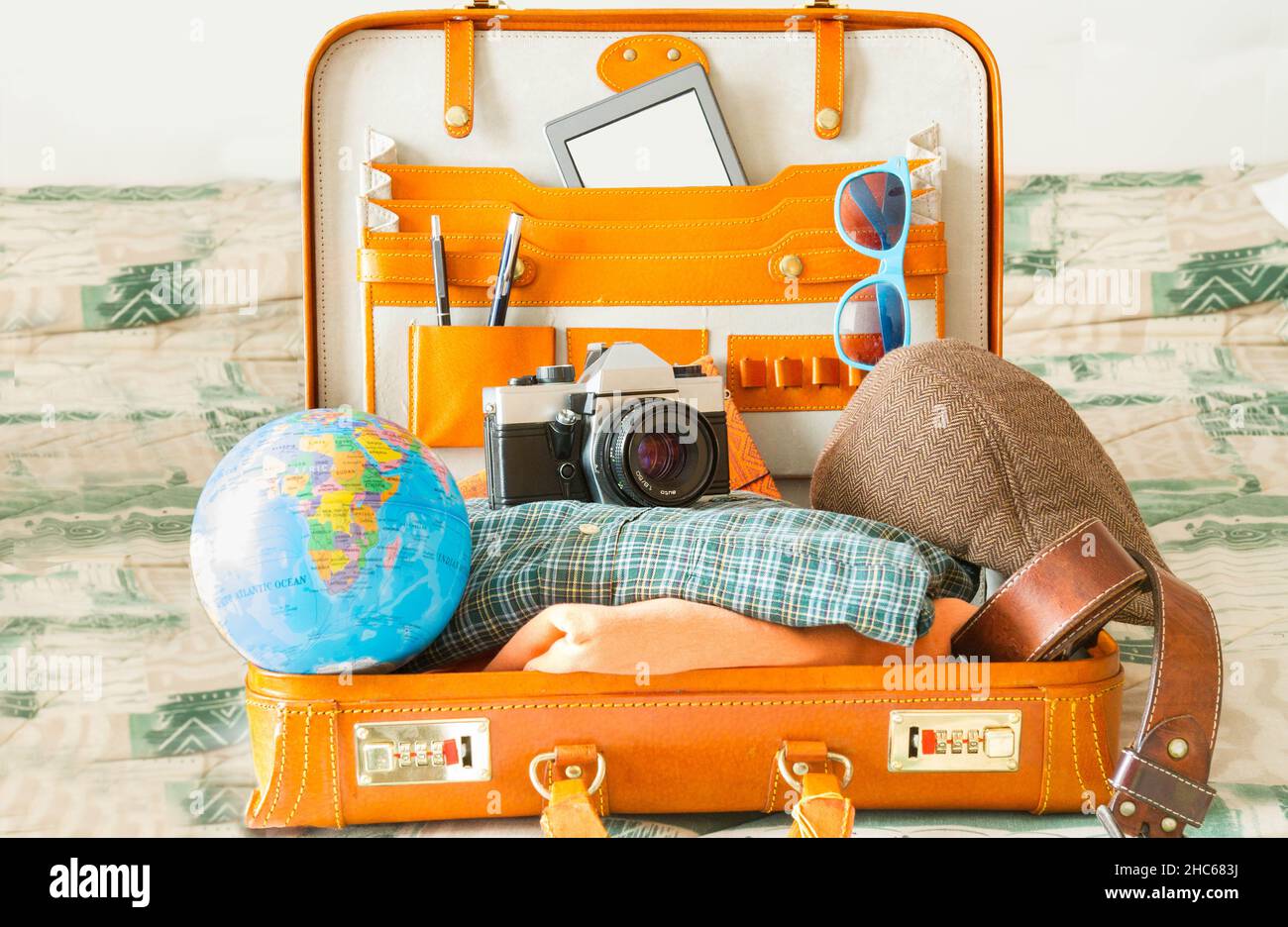 Suitcase full of items for travel. Illusion, hope, joy and new