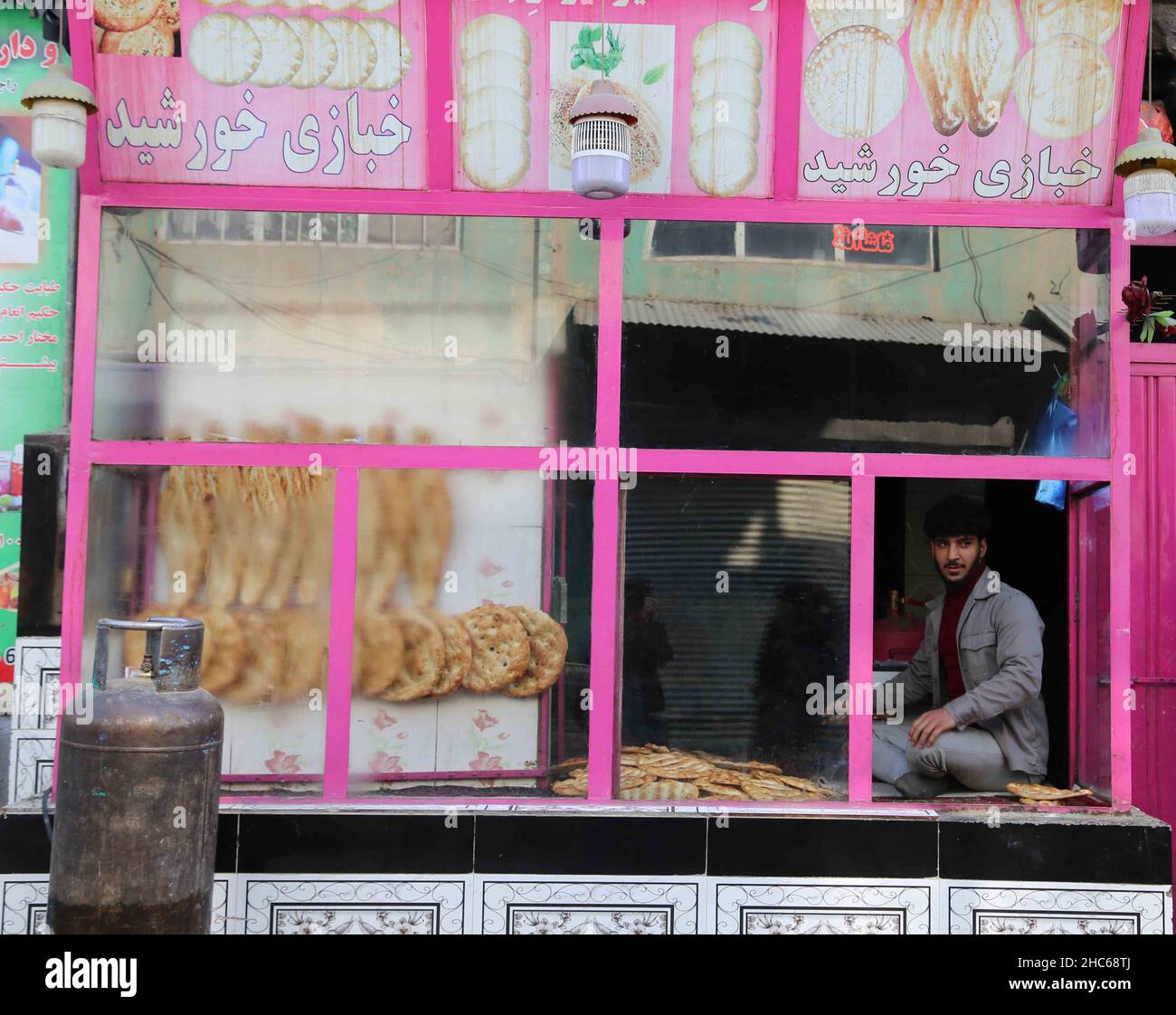 Kabul, Afghanistan. 24th Dec, 2021. An Afghan man waits to sell bread