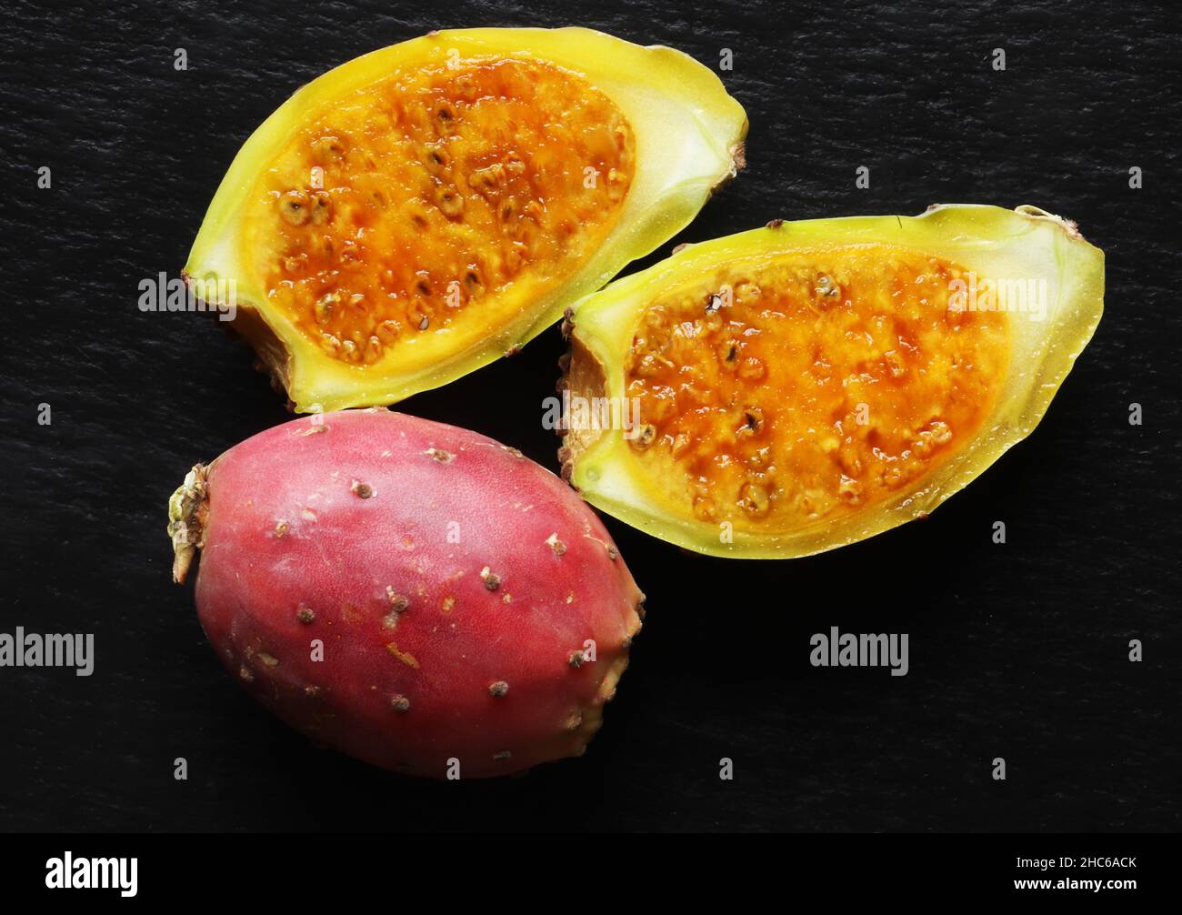 Photography of two prickly pears, one whole the other open Stock Photo ...
