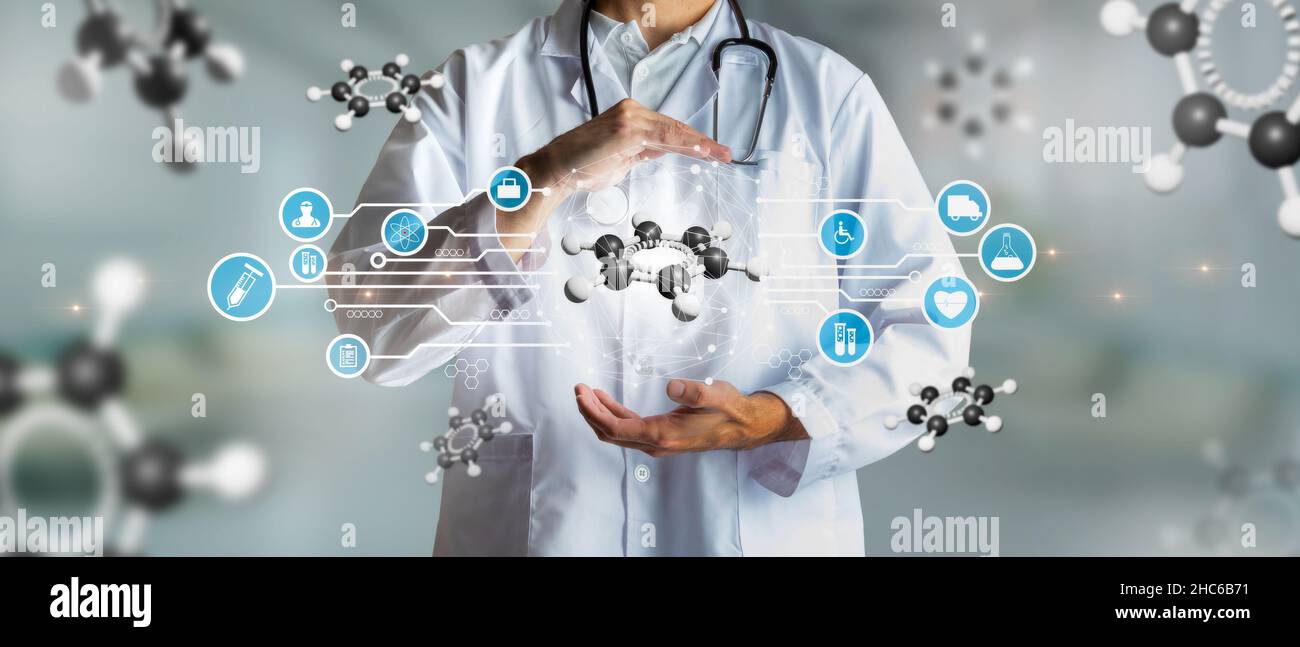 Doctor holding a carbon atom in concept of science and innovation. Medical future technology and innovative concept. Mixed Media Stock Photo