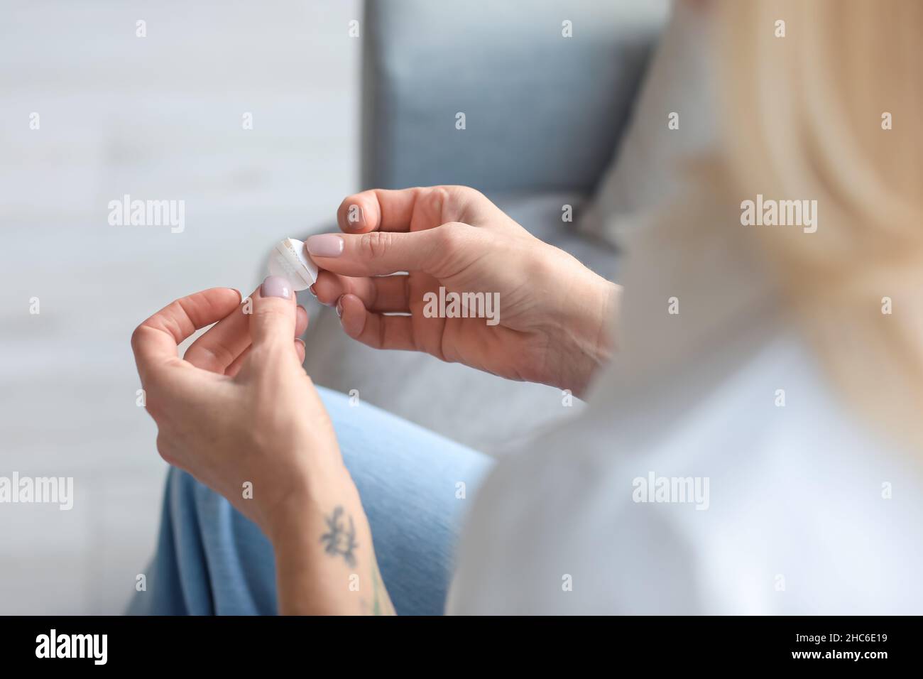 Mature woman with nicotine patch at home, closeup. Smoking cessation Stock Photo