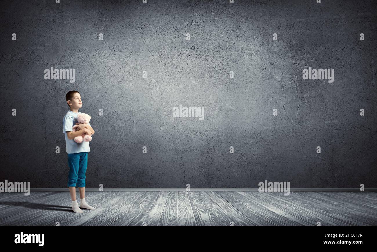 Boy with bear toy Stock Photo - Alamy