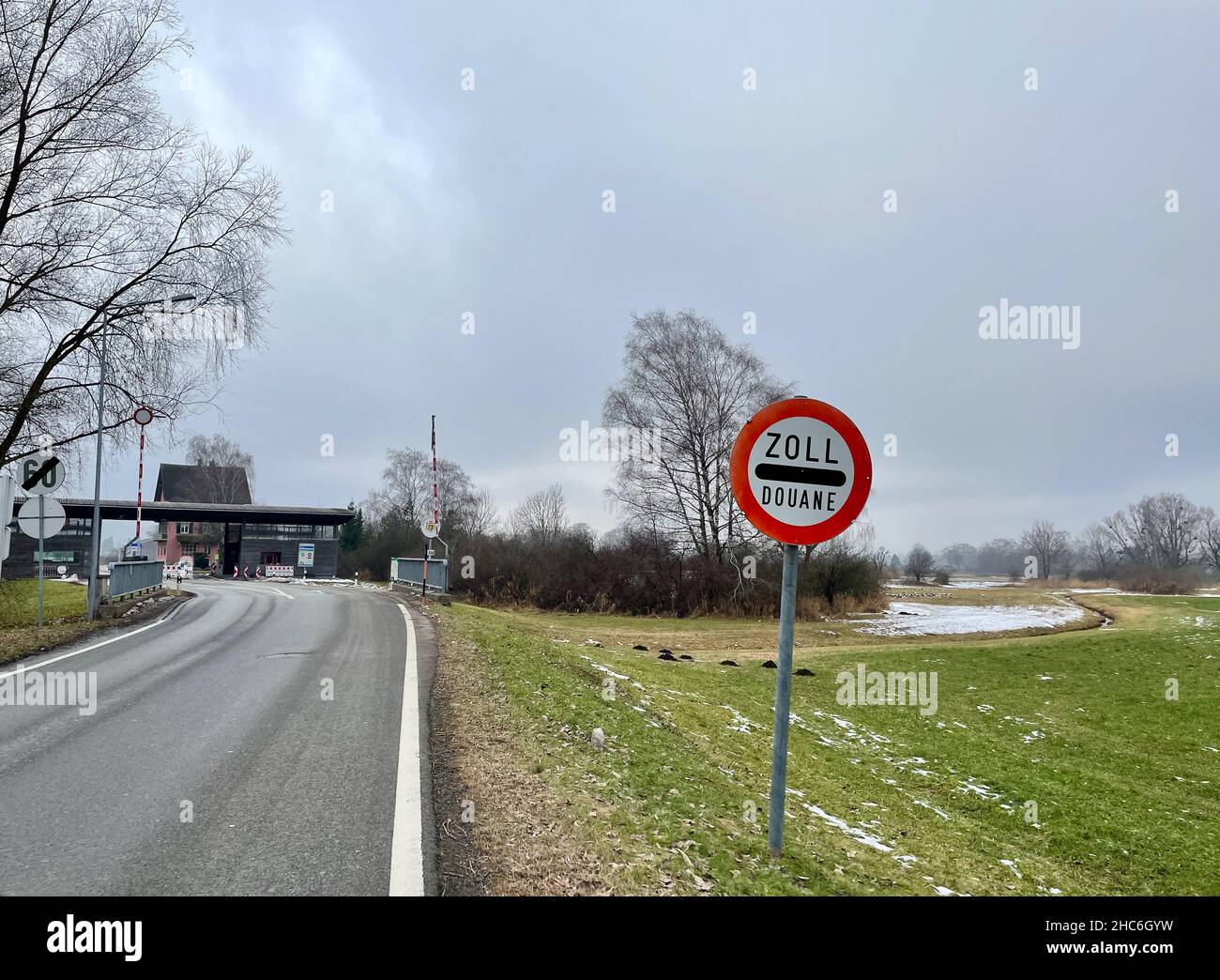 Feldkirch, Austria, 19.12.2021. Rural border crossing between Austria and Liechtenstein with road sign indicating customs, Zoll, douane. Stock Photo