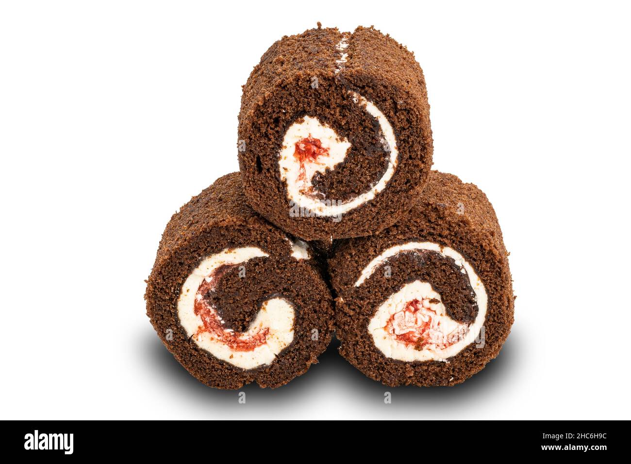 Pile of homemade chocolate Mini Black Forest Cake Roll filled with white cream on white background with clipping path. Stock Photo