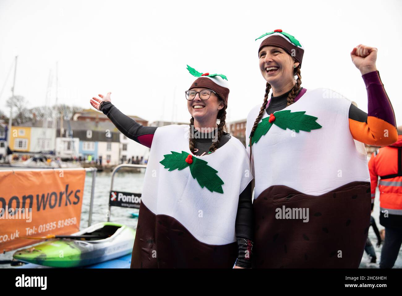Weymouth, UK. 25th December, 2021. Two friends dressed as Christmas