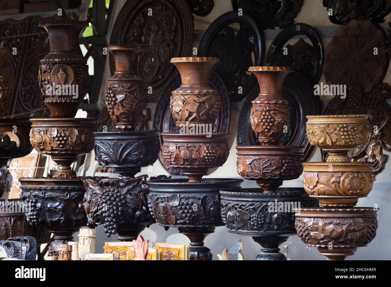 Wooden souvenir vases of different size and shape, with engravery of wine grapes and leaves and other ornaments Stock Photo