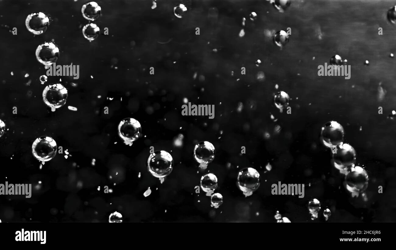 Beautiful transparent bubbles in water moving slowly. Close up of many