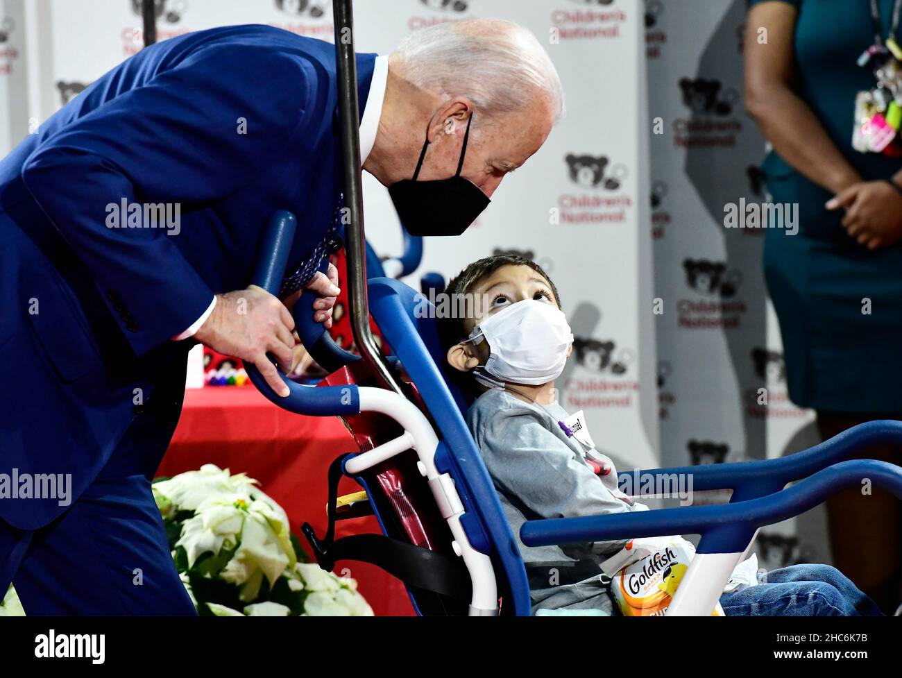 United States President Joe Biden converses with Samuel as he looks at craft projects created by patients at Children's National Medical Center in Washington, DC on Christmas Eve, Friday, December 24, 2021.Credit: Ron Sachs/Pool via CNP /MediaPunch Stock Photo