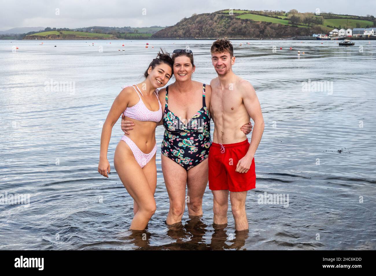 Bantry, West Cork, Ireland. 25th Dec, 2021. A number of people went for a Christmas swim in Bantry this afternoon in a flat calm sea. Having a dip were Erin, Jacinta and Matthew Barry from Bantry. Credit: AG News/Alamy Live News Stock Photo