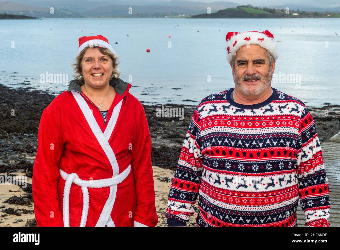 Bantry, West Cork, Ireland. 25th Dec, 2021. A number of people went for a Christmas swim in Bantry this afternoon in a flat calm sea. Preparing to have a dip were Sonia Taylor and Shane Begley from Bantry. Credit: AG News/Alamy Live News Stock Photo