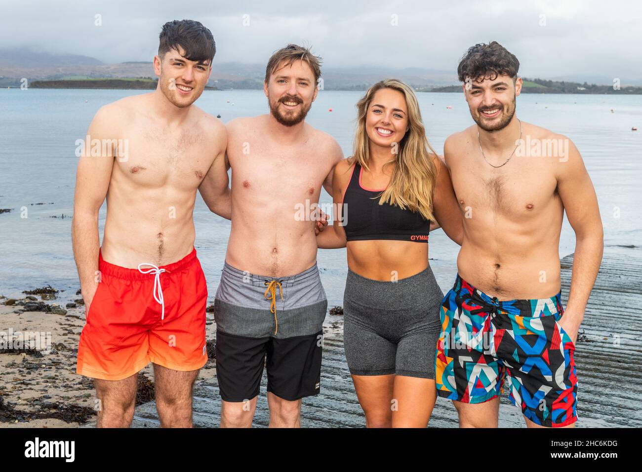 Bantry, West Cork, Ireland. 25th Dec, 2021. A number of people went for a Christmas swim in Bantry this afternoon in a flat calm sea. Preparing to have a dip were Shane Keevers, Roman Decomble and Rachel & Brian Murphy from Bantry. Credit: AG News/Alamy Live News Stock Photo