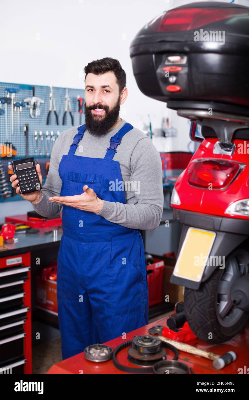 Smiling male worker counting sum for his service Stock Photo - Alamy