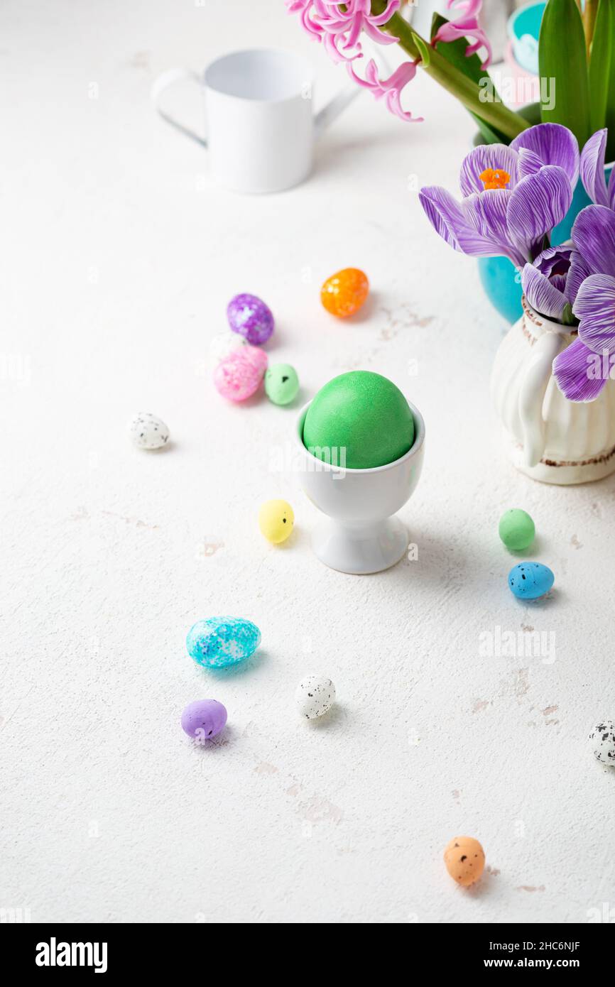 One green Easter eggs and decoration eggs on light table Stock Photo