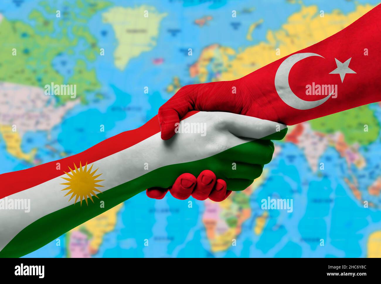 Handshake between Kurdistan and Turkey flags painted on hands.With