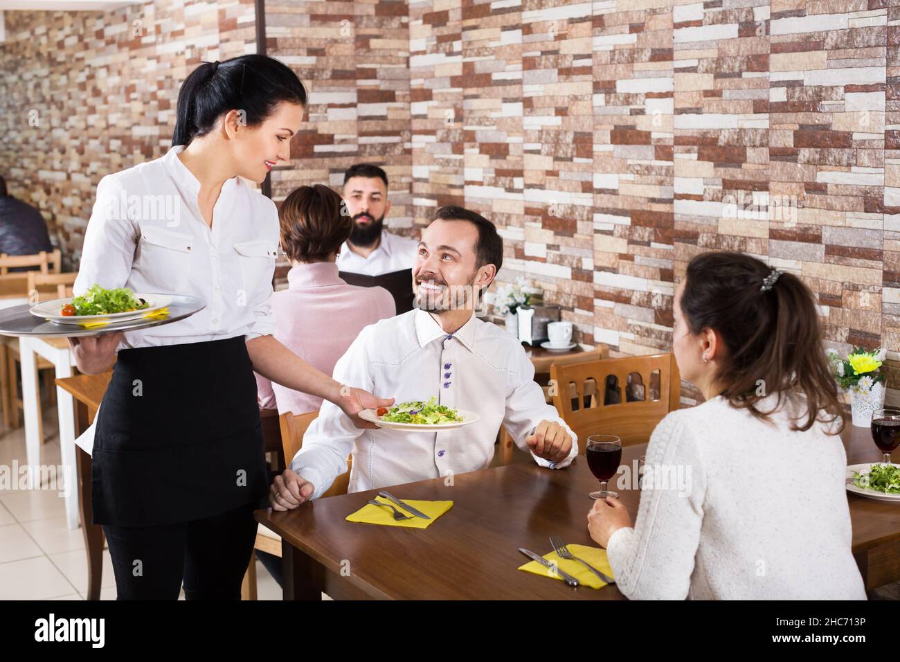 Waitress taking table order at tavern Stock Photo Alamy