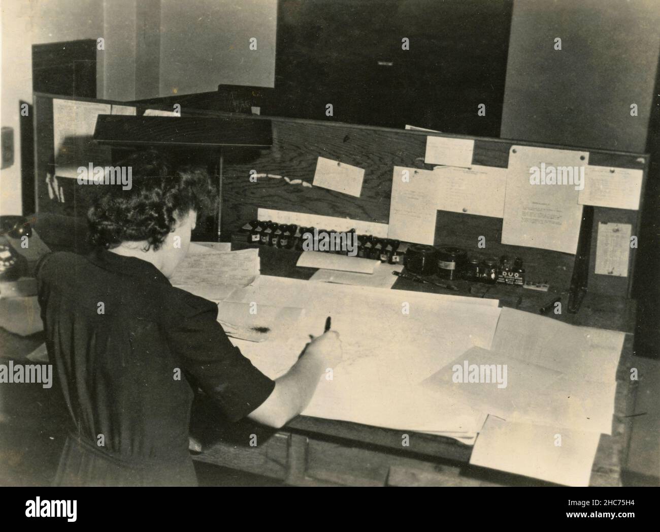 Woman Working at a Teletype Map Weather Reports, NY Weather Bureau, USA 1960s Stock Photo