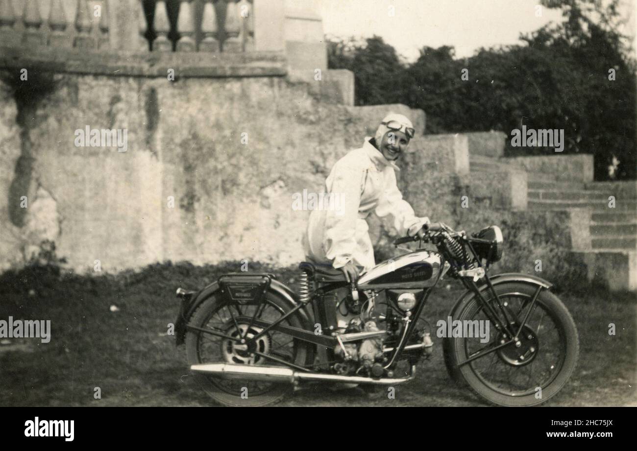 Girl in white Overall with a Moto Guzzi P 175cc motorbyke, Italy 1936 Stock Photo