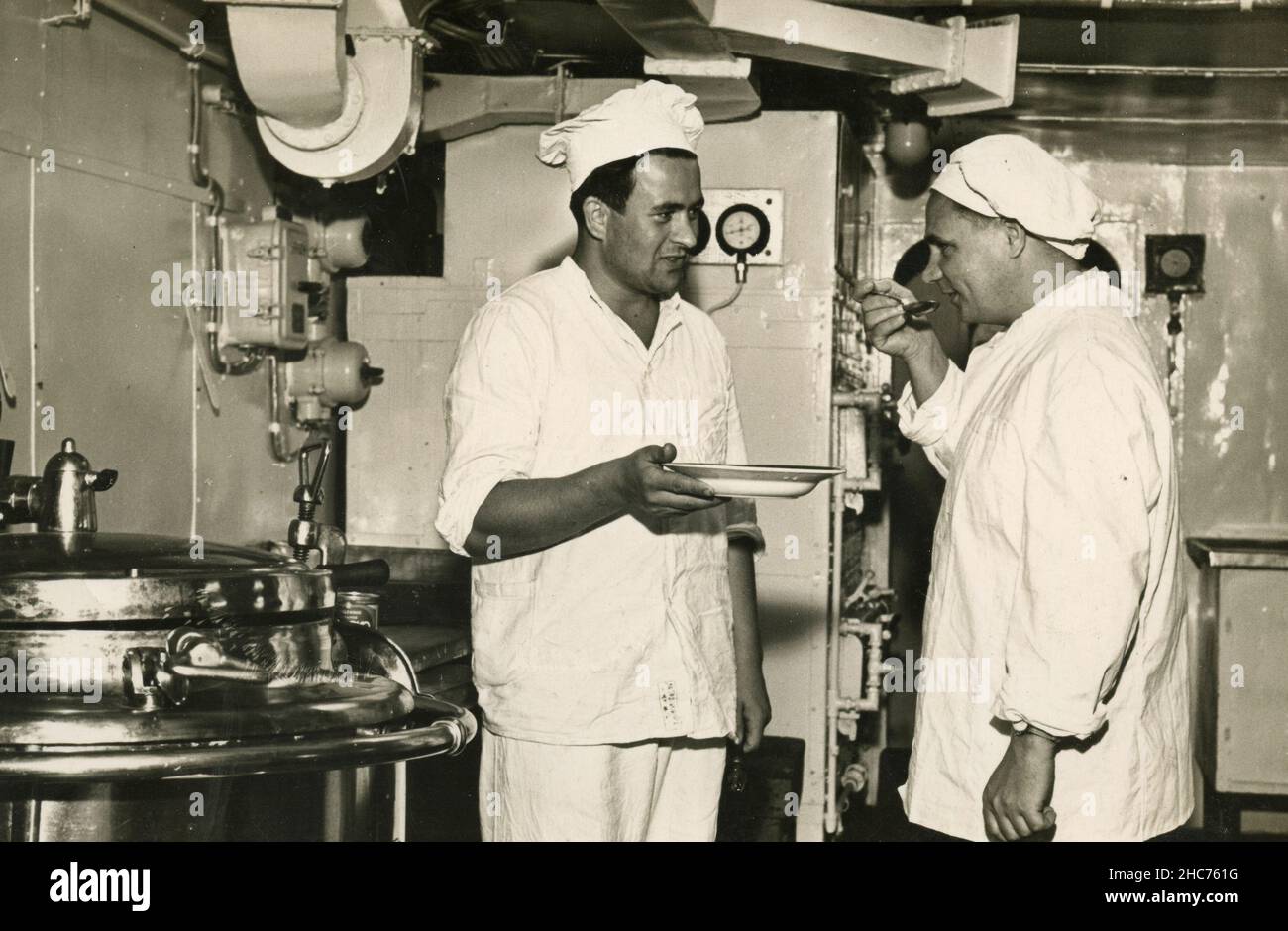 Cooks tasting the food onboard the ship, Italy 1950s Stock Photo