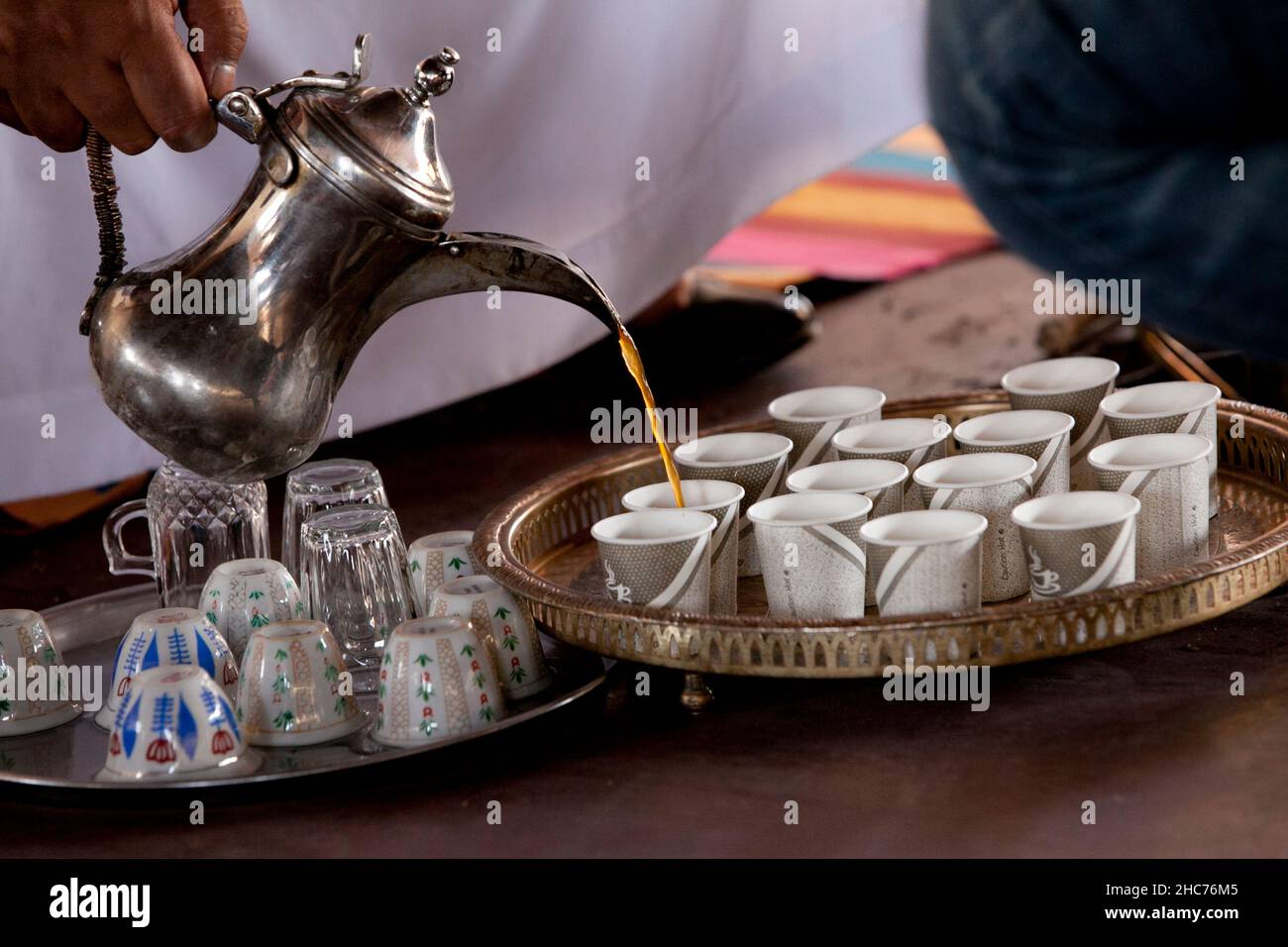 Pouring coffee into cups in a Bedouin tent Stock Photo