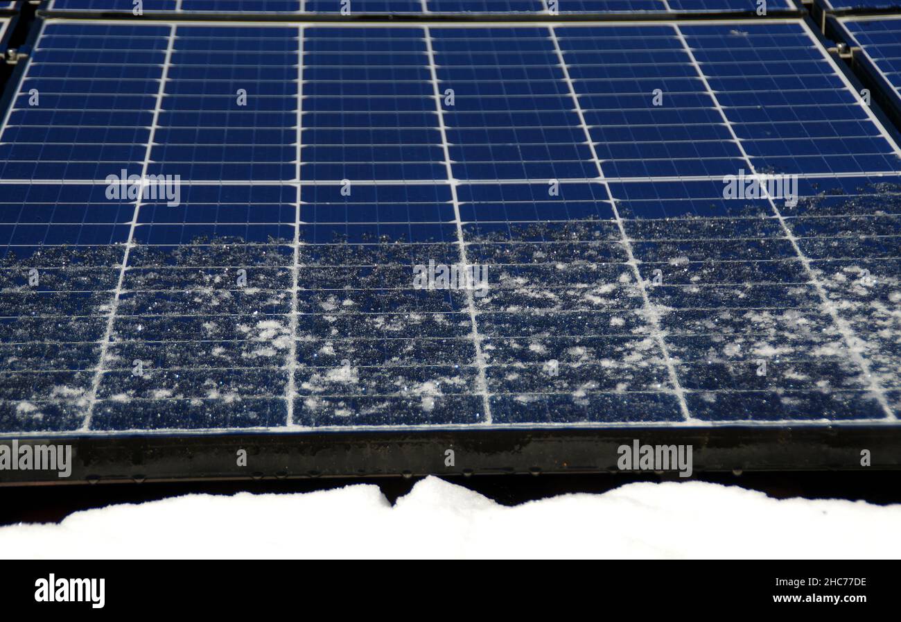 Solar panels covered by snow. Photovoltaic electricity installation on