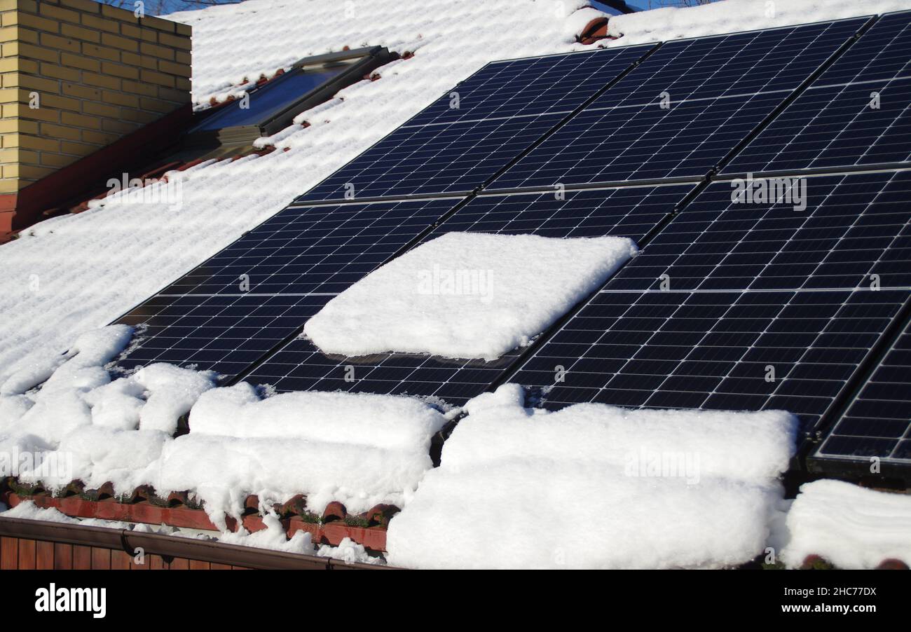 Solar panels covered by snow. Photovoltaic electricity installation on