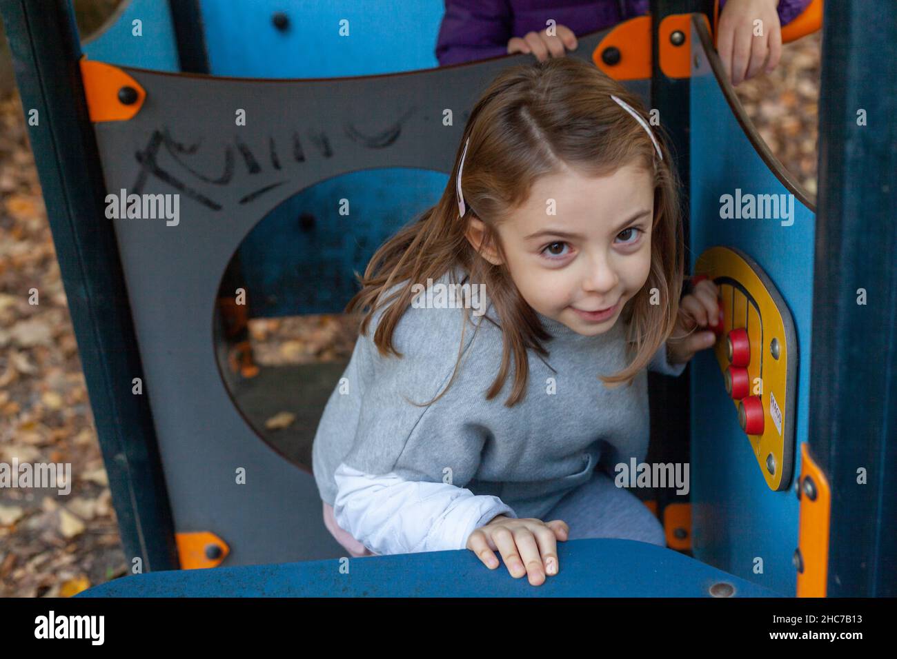 Adorable little girl playing in the playground Stock Photo - Alamy