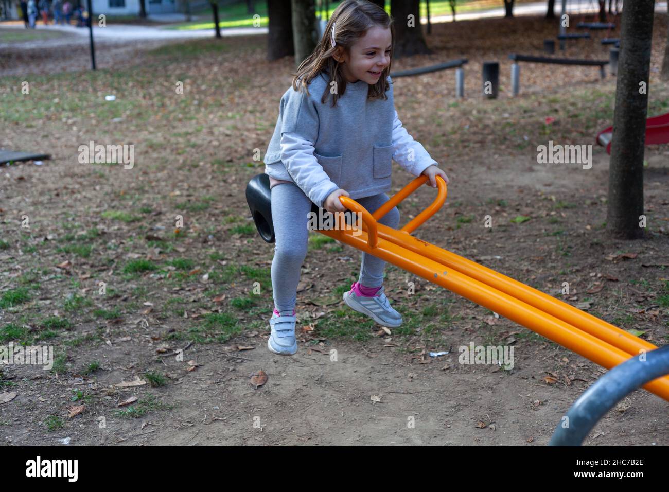 Adorable little girl playing in the playground Stock Photo - Alamy