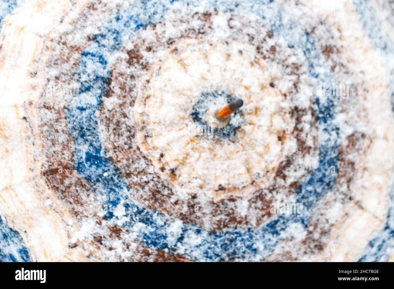 Defocus twist and shakes snowy blue and brown umbrella outside on nature winter snowy forest background. Cold weather. Happy holidays. Close-up. Meteo Stock Photo