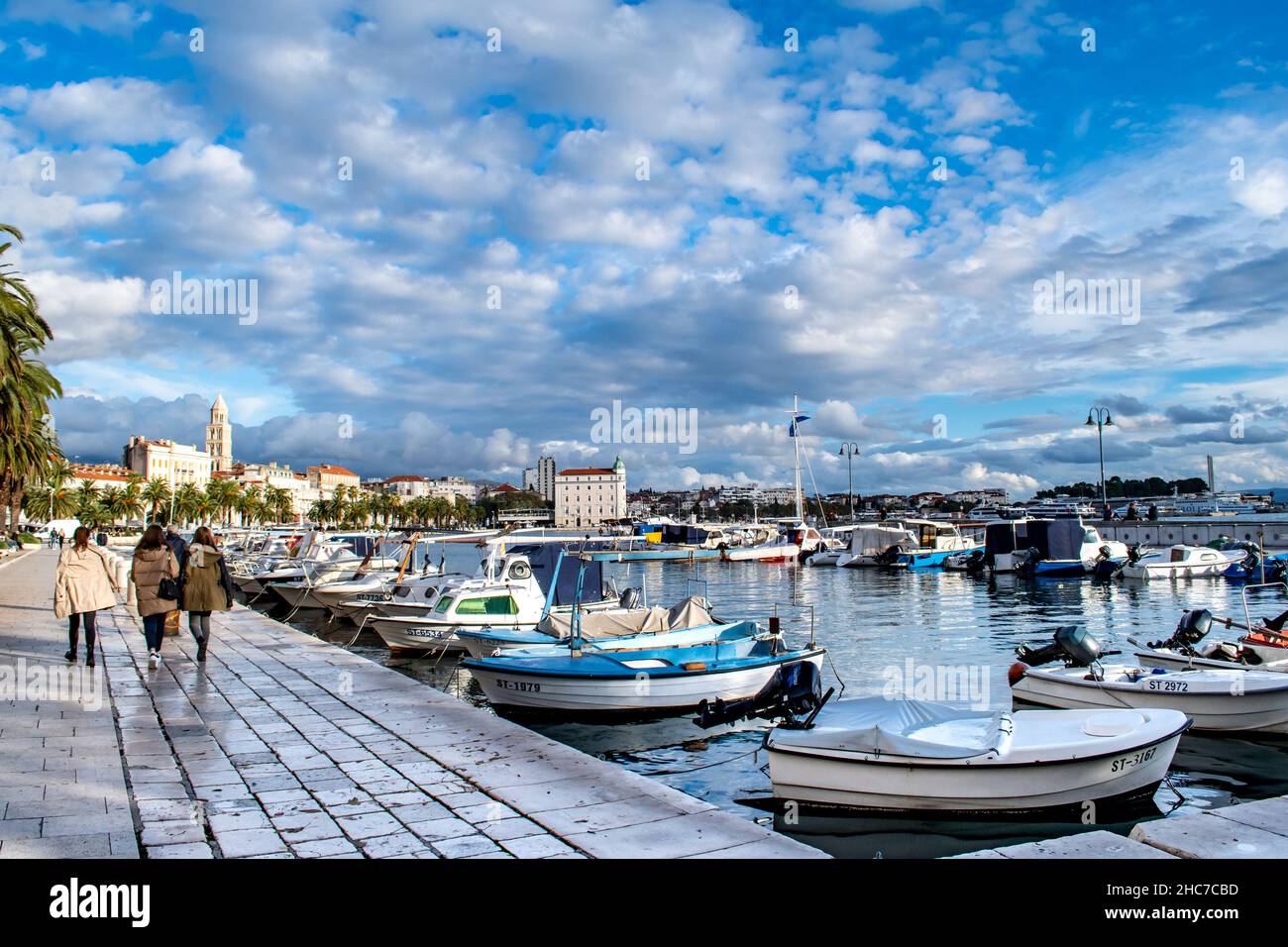 Split, Croatia-November 27, 2021: Boats in the calm blue harbor waters of the seaport along the Adriatic Sea, Dalmatia Coast, Travel/Tourism Stock Photo