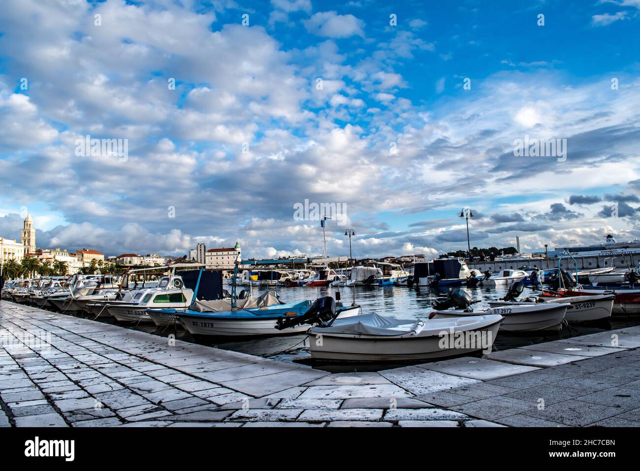 Split, Croatia-November 27, 2021: Boats in the calm blue harbor waters of the seaport along the Adriatic Sea, Dalmatia Coast, Travel/Tourism Stock Photo