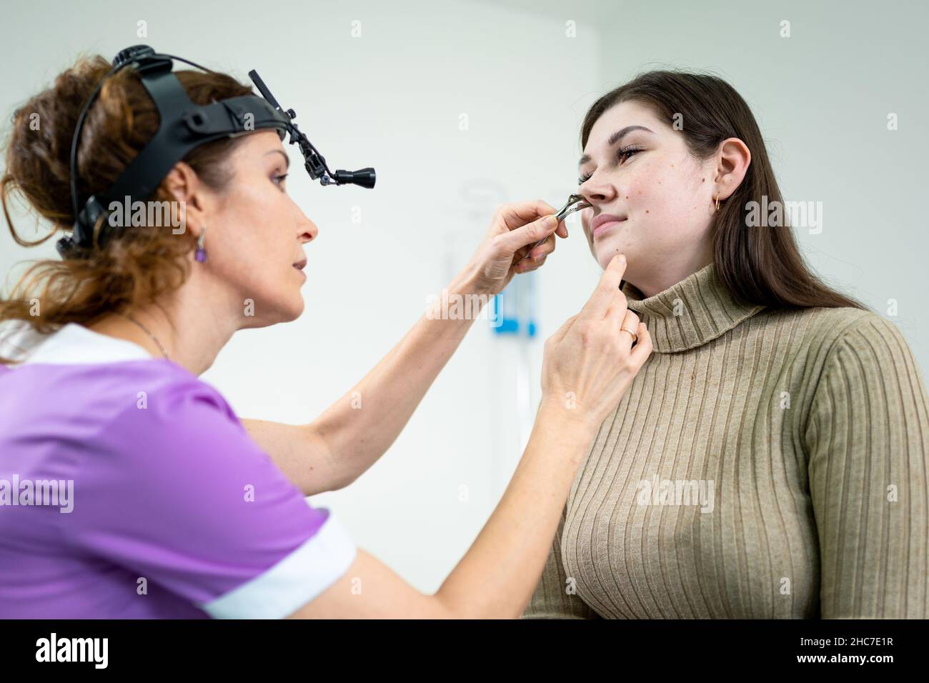 Otolaryngology concept. Positive woman otorhinolaryngologist checking