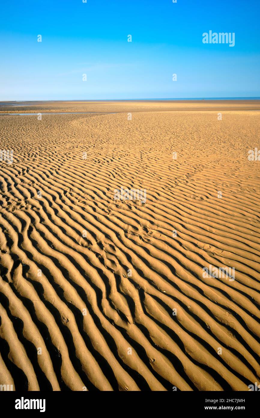 Beach view blue sky yellow sand and ripples Minimalist Landscape Stock Photo