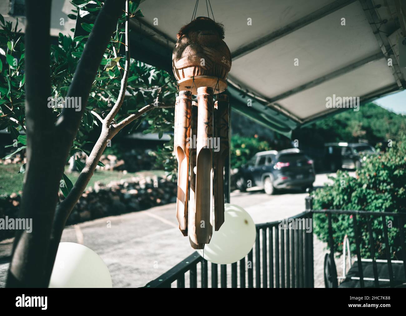 A wooden object hanging on the outdoors balcony Stock Photo