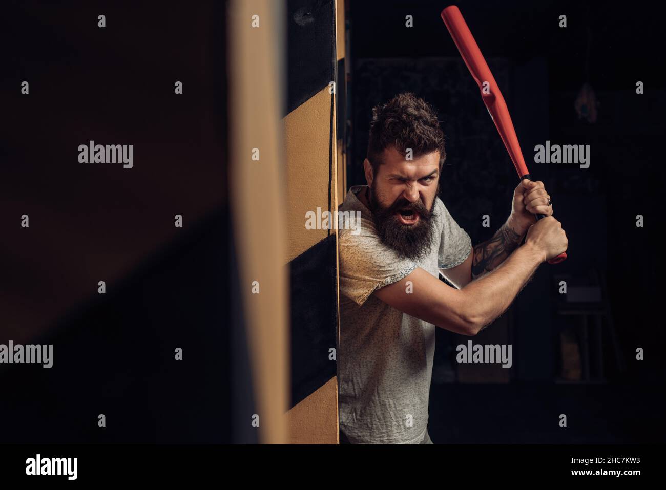 Brutal angry gang man lifestyle, serious handsome guy holding baseball bat  Stock Photo - Alamy