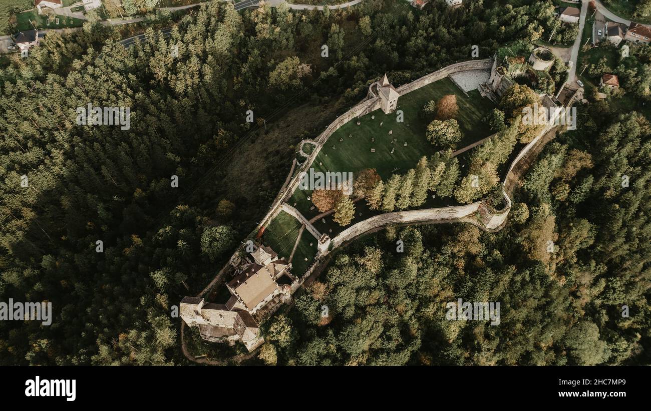 Aerial shot of the ancient beautiful Ostrozac castle surrounded by dense forests Stock Photo