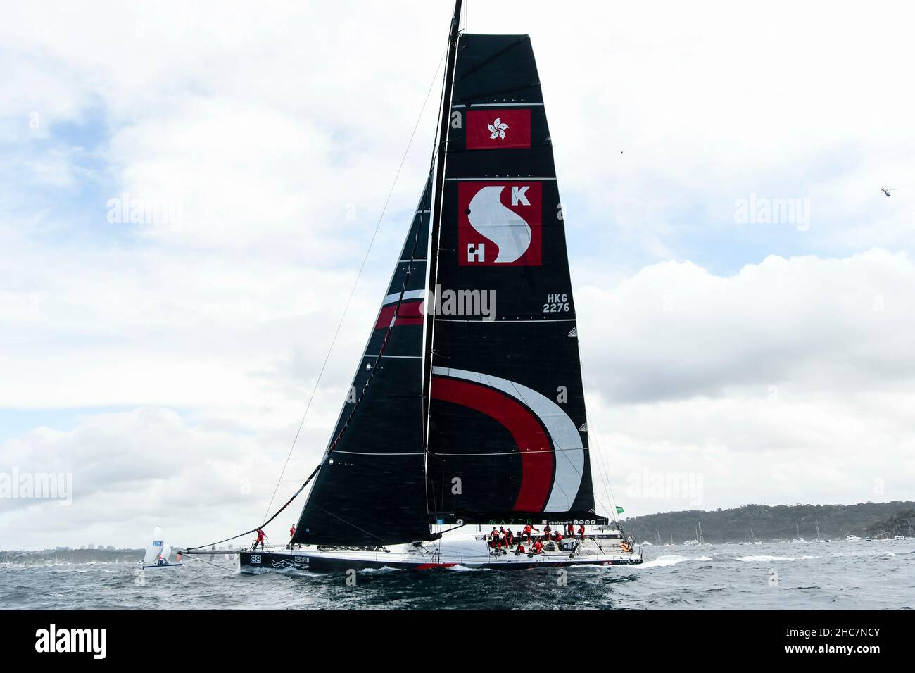 Sydney Harbour, Sydney, Australia. 26th Dec, 2021. Rolex Sydney Hobart Yacht Race; SHK SCALLYWAG 100 skippered by David Witt lead the race as the fleet approaches the Heads Credit: Action Plus Sports/Alamy Live News Stock Photo