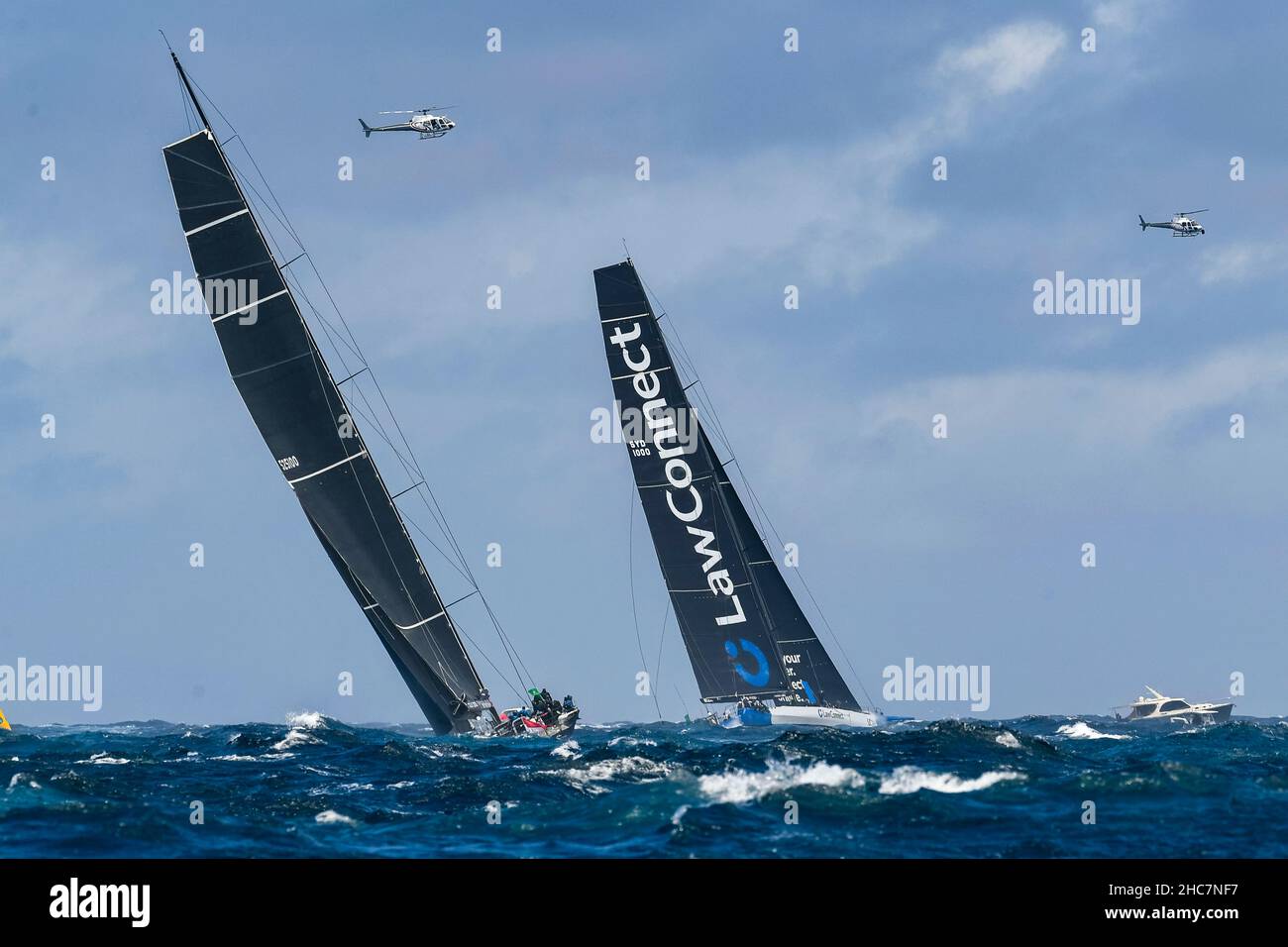 Sydney Harbour, Sydney, Australia. 26th Dec, 2021. Rolex Sydney Hobart  Yacht Race; BLACK JACK skippered by Mark Bradford and LAWCONNECT skippered  by Christian Beck leave the Heads and turn south towards Hobart