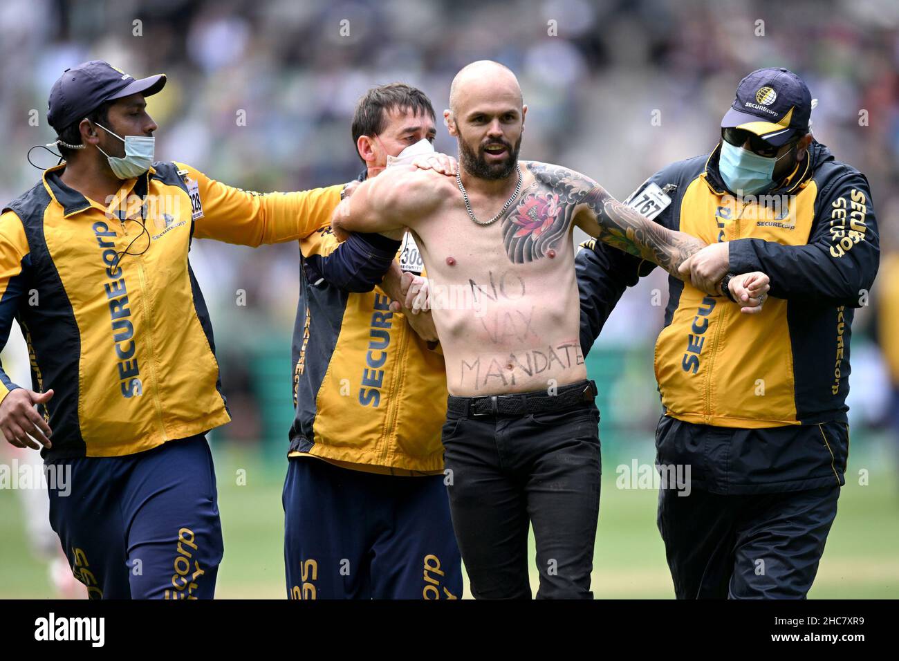Melbourne Cricket Ground, Melbourne, Australia. 26th Dec, 2021. The Ashes 3rd Test Day 1 Cricket, Australia versus England; A man with anti vaccine mandate messages written on his body runs onto the MCG pitch during play, causing a delay Credit: Action Plus Sports/Alamy Live News Stock Photo