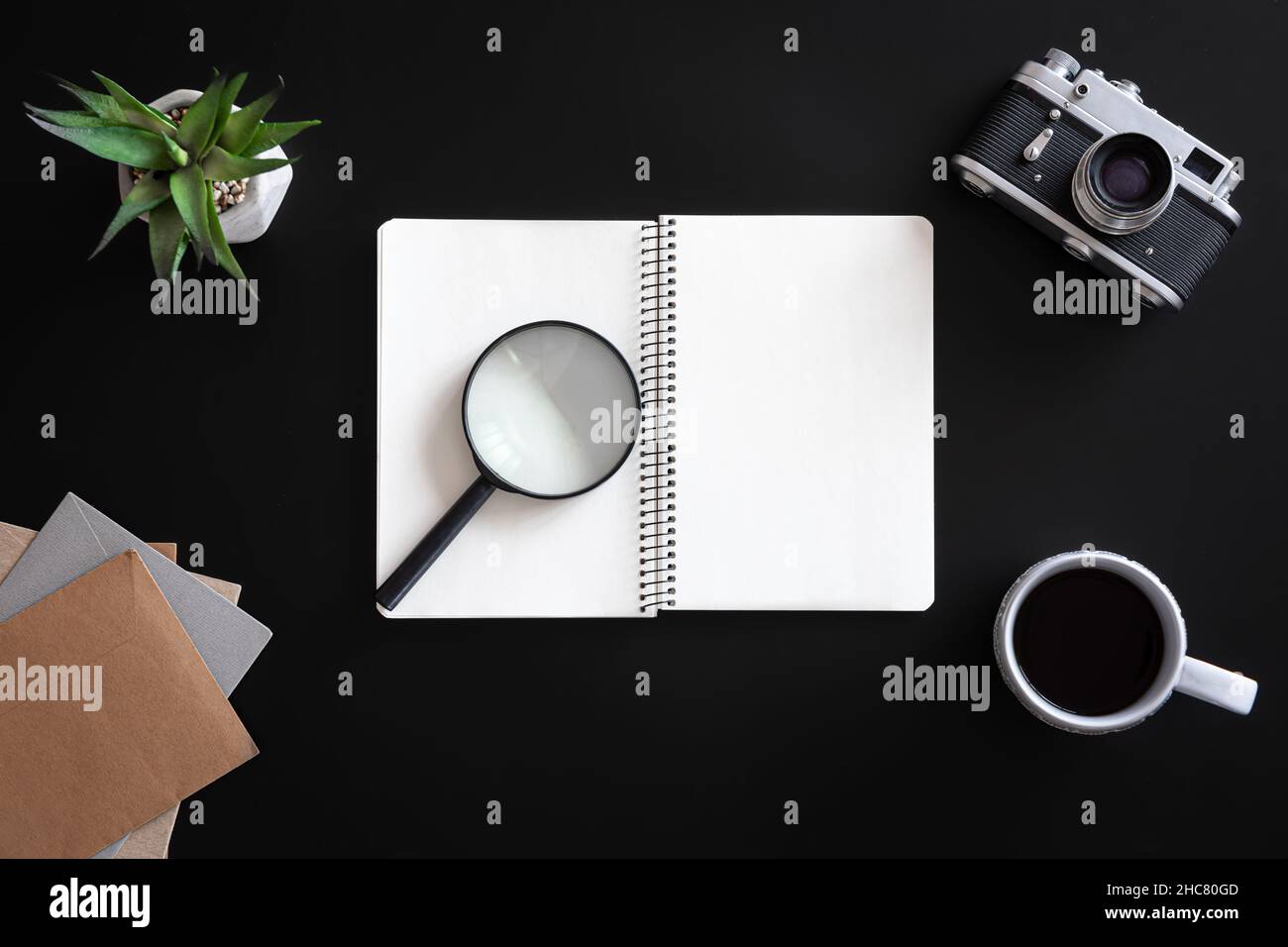 Open blank notebook on black background, flat lay. Stock Photo