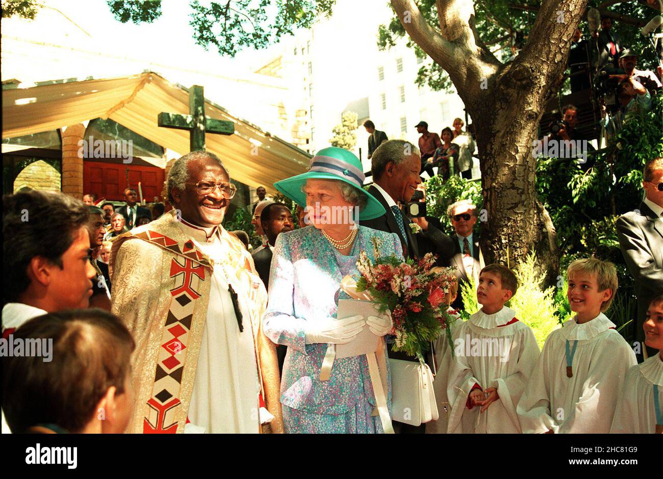 File photo dated 21/03/95 of Queen Elizabeth II talking with Archbishop Desmond Tutu as she and President Nelson Mandela leave St George's Cathedral in Cape Town, after attending a service to mark human rights day. Desmond Tutu, the Nobel Peace Prize-winning activist for racial justice and LGBT rights, has died aged 90. He had been treated in hospital several times since 2015, after being diagnosed with prostate cancer in 1997. Issue date: Sunday December 26, 2021. Stock Photo