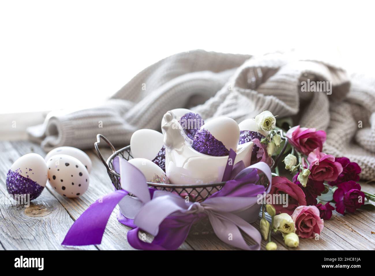 Easter composition with eggs, decorated with purple sparkles. Stock Photo