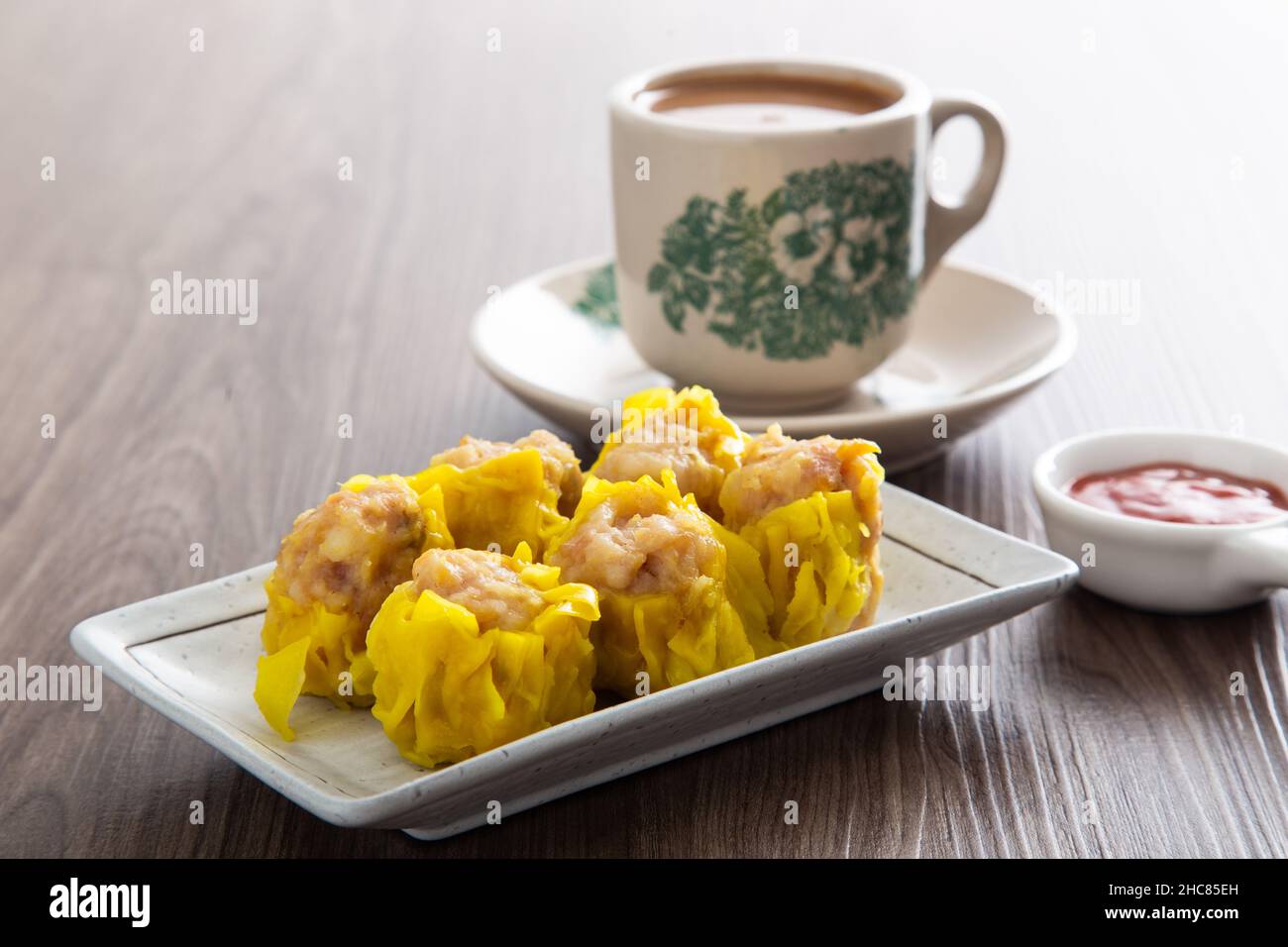 Siu Mai Chinese steamed pork dumplings in bamboo steamers Stock Photo